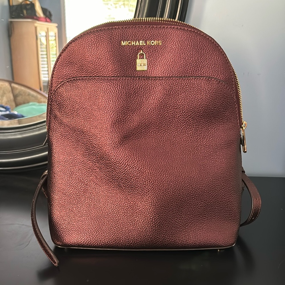 Never worn backpack. Such a cute burgundy metallic color with gold hardware.